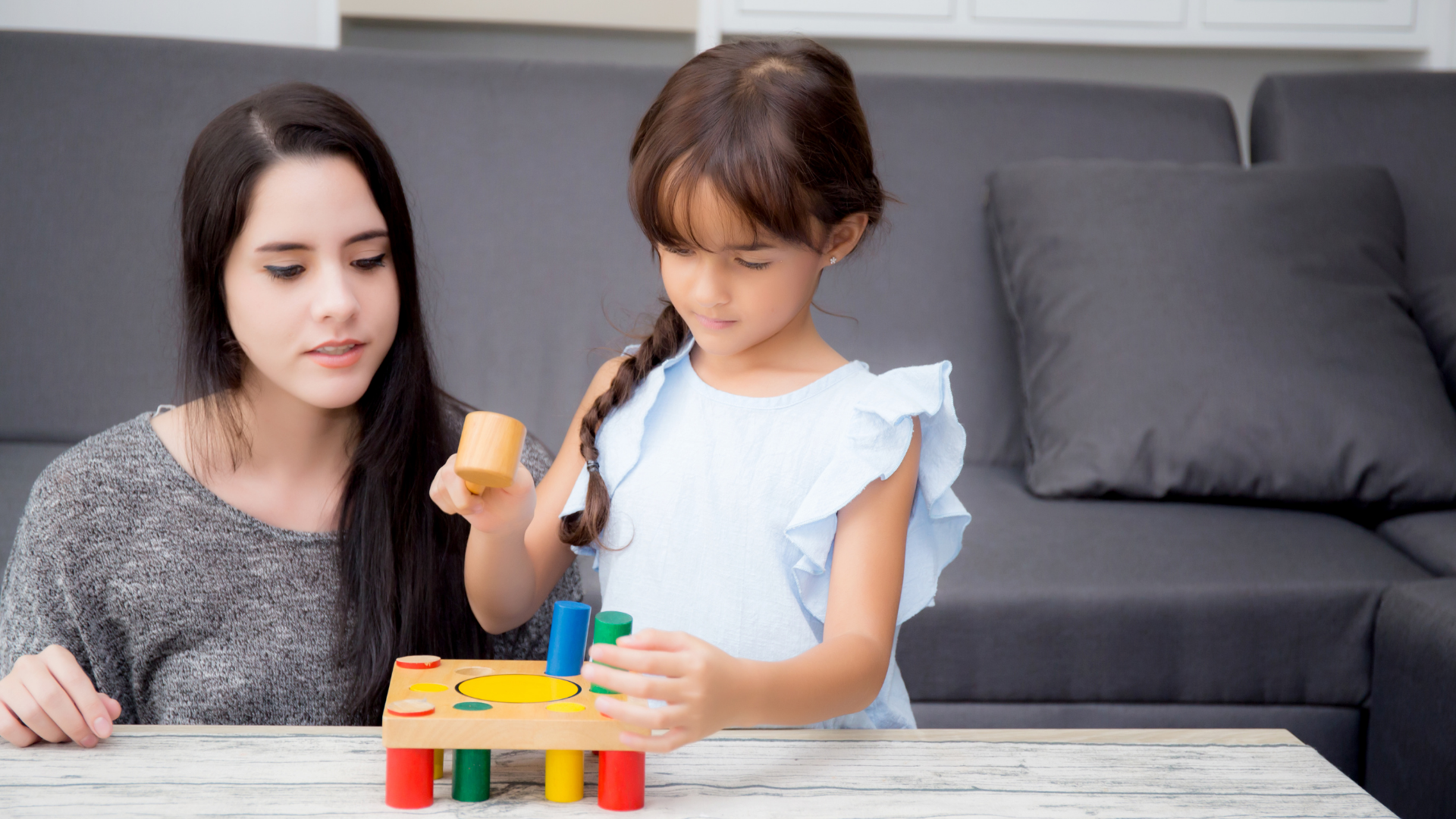 mother and daughter playing with shape sorter toy